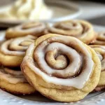 cinnamon roll cookies with glaze on a white plate