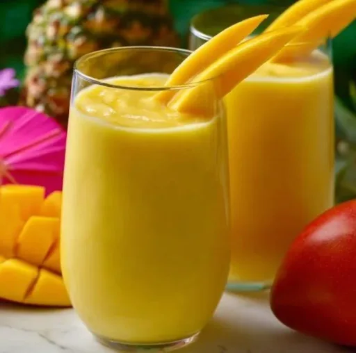 Delicious homemade McDonald's Mango Smoothie in a glass with fresh mango slices.