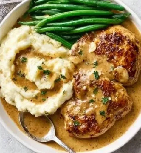 Creamy garlic chicken served on a plate garnished with herbs