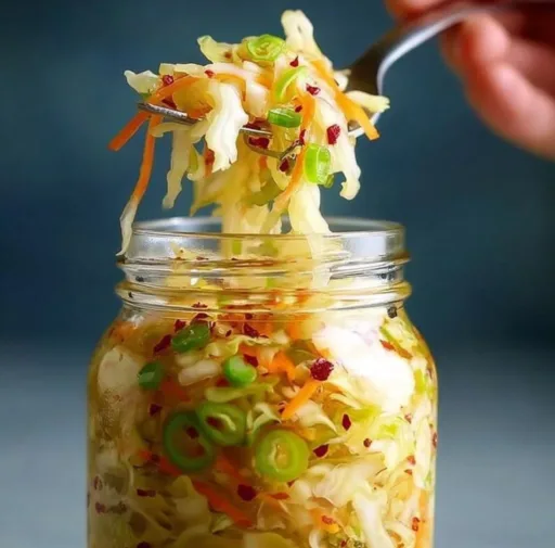A jar of fermented cabbage showcasing its vibrant color and texture.