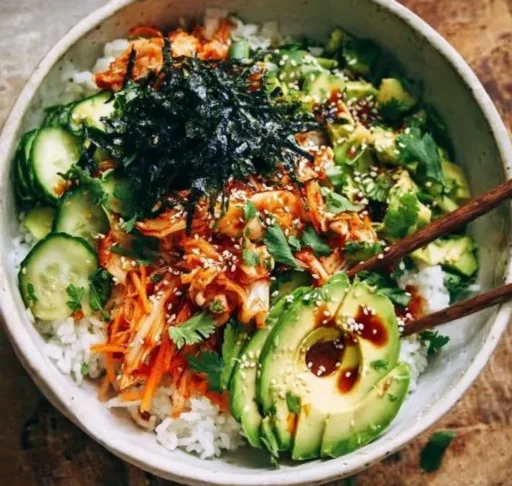Delicious kimchi rice bowl with vegetables and garnishes