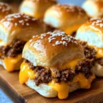 Homemade cheeseburger sliders served on a platter with dipping sauces.