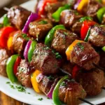 Grilled steak kabobs with colorful vegetables on a barbecue grill