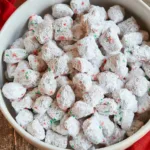 A festive bowl of Christmas Puppy Chow with holiday decorations