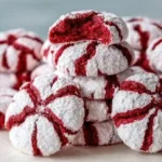 Freshly baked red velvet cookies with cream cheese frosting on a plate