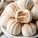Plate of homemade snickerdoodle truffles coated in cinnamon sugar